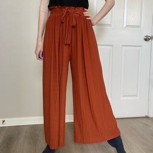 Orange pleated flowy pants